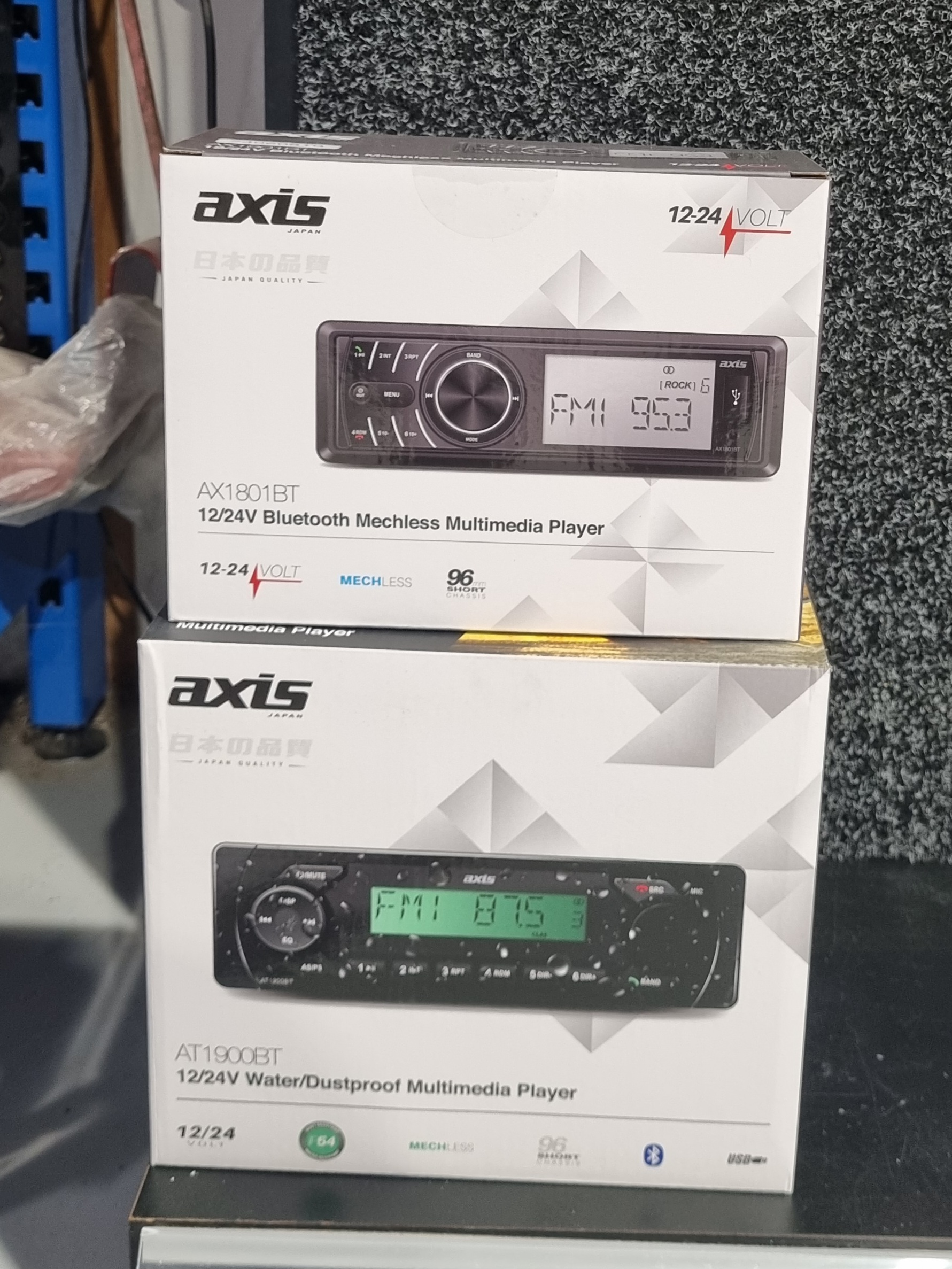 Axis twelve and twenty four volt Bluetooth head units on the counter