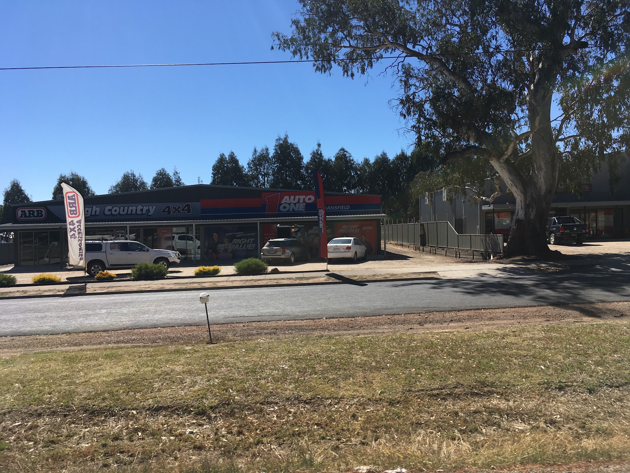 The High Country 4x4 and Auto One Mansfield shopfront on Mt Buller Road with ARB flags outside