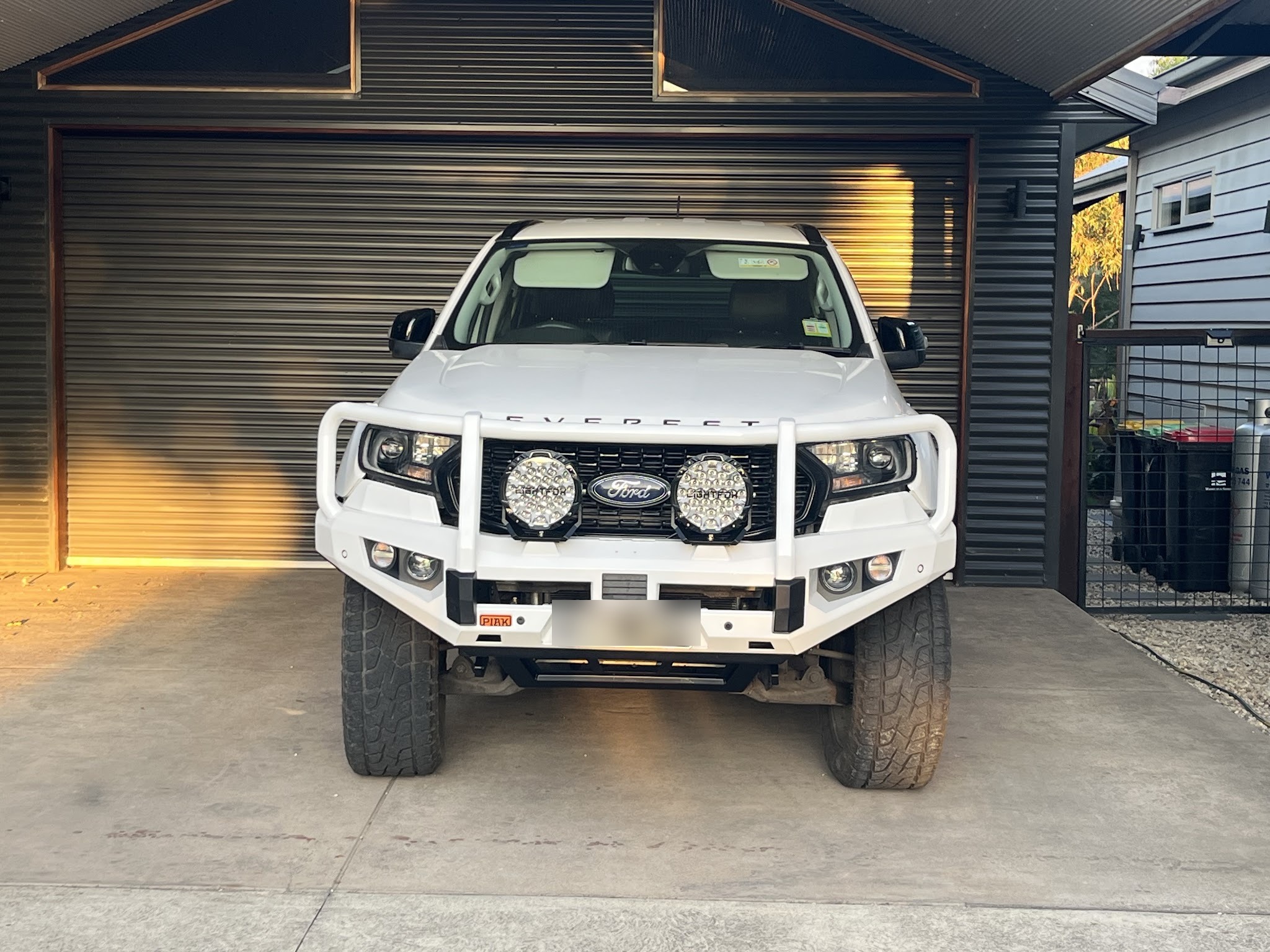 White Ford Everest fitted with a white PIAK bull bar and Lightforce driving lights